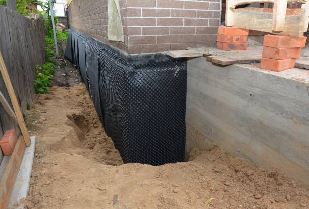 Happy homeowners after waterproofing job in Butlerville